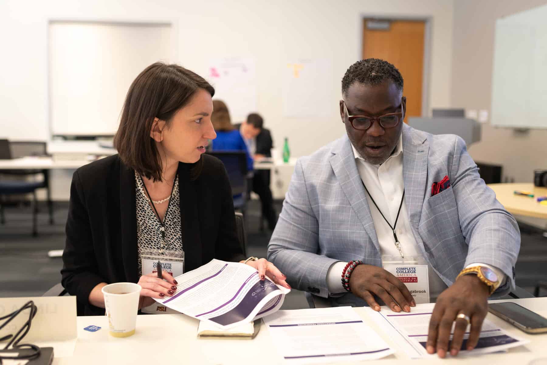 Collaborative diverse group of professionals discussing college success strategies at a conference for Complete College America, emphasizing higher education achievement and completion.