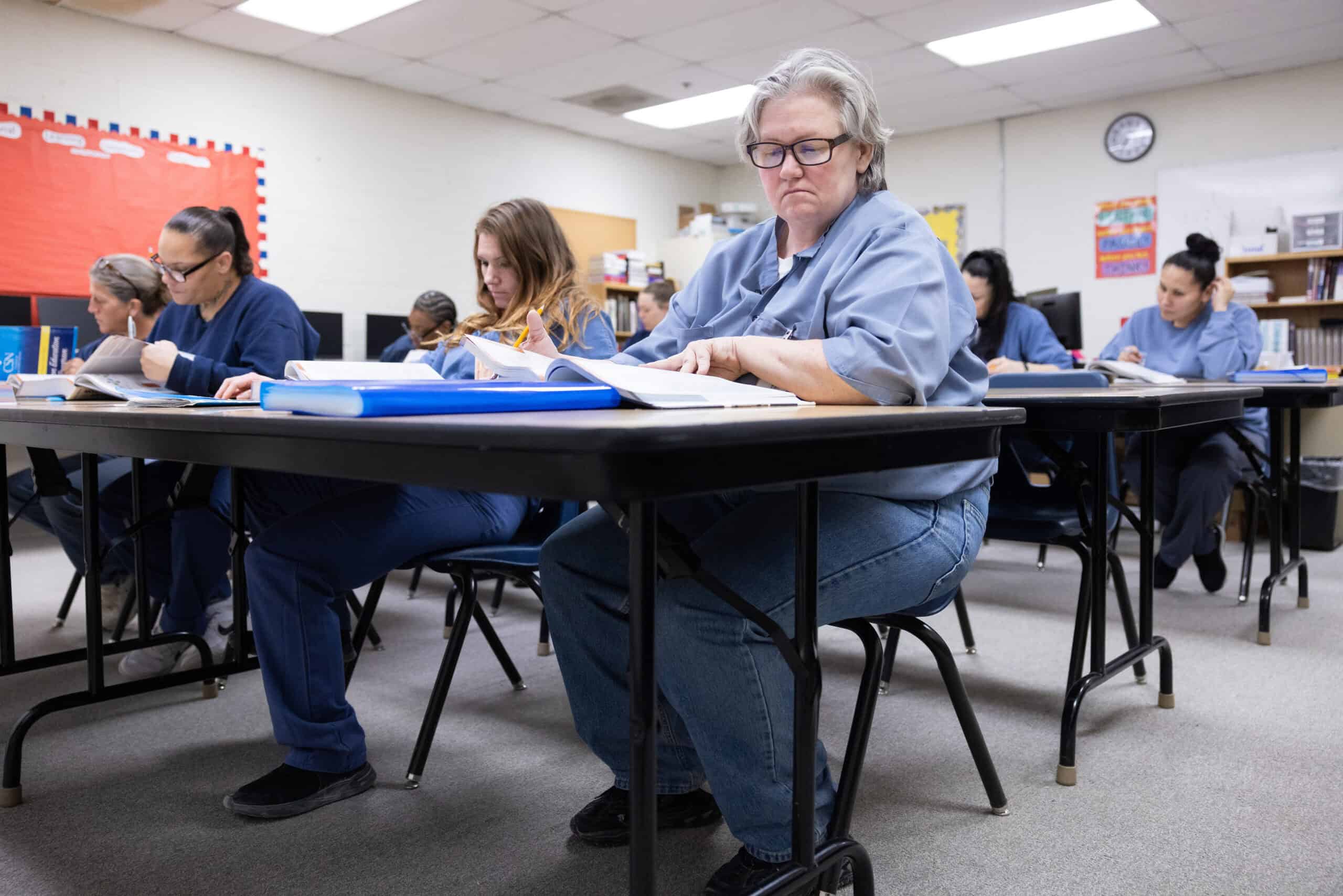 Hardworking students studying in classroom, focusing on college coursework and achieving academic success, illustrating the importance of education and college readiness.