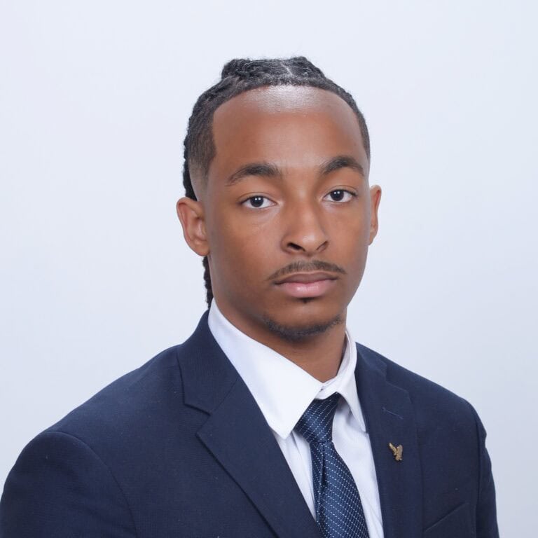 Innovative young professional in formal suit, representing Complete College America initiatives for college success and achievement.