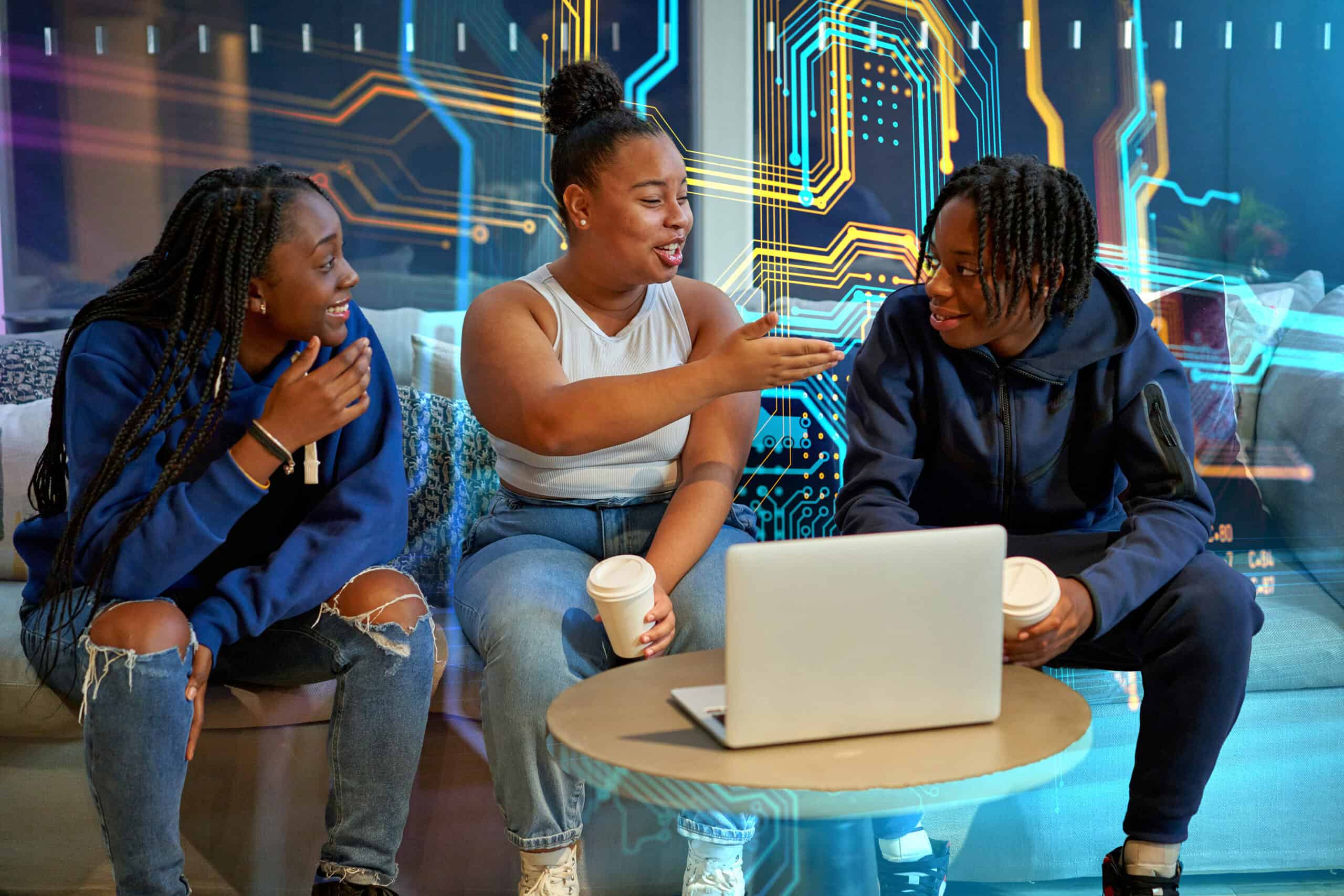 Collaborative students discussing technology and innovation in a modern learning environment, emphasizing the importance of digital literacy in higher education and college success.