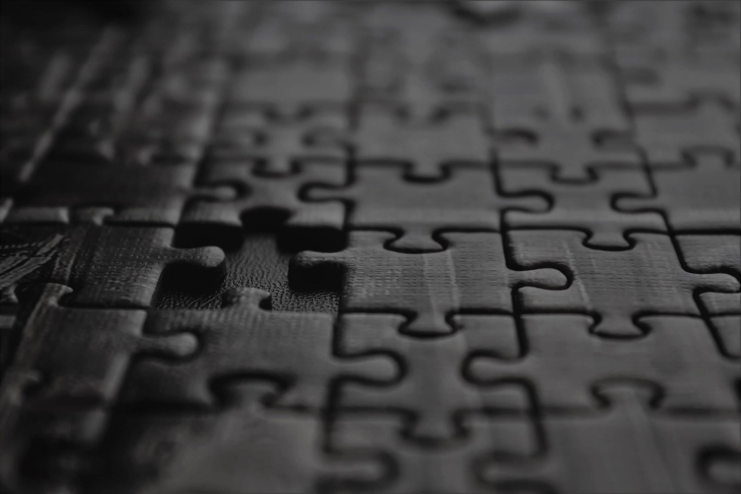 Puzzle pieces fitting together to symbolize collaboration and problem-solving in higher education.