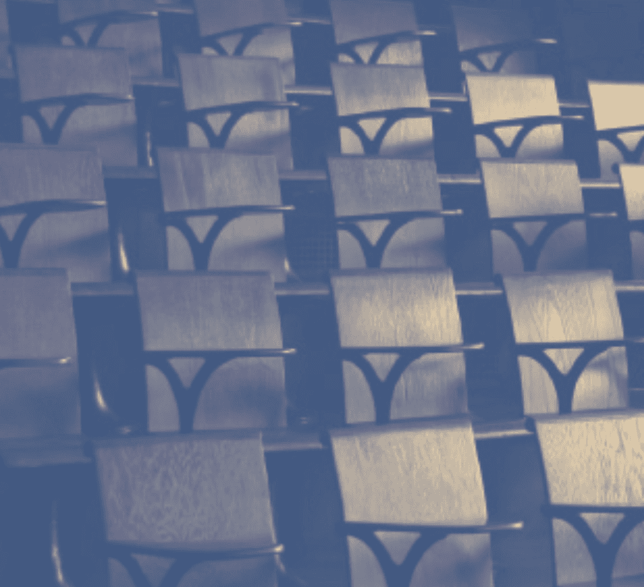 Empty college auditorium seats arranged in rows.