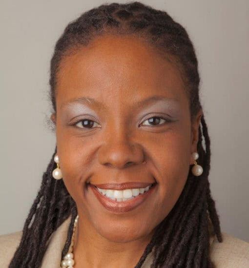 Graduation woman smiling, diversity, college achievement, Complete College America initiatives, higher education success, student empowerment, graduation celebration.
