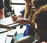 A diverse group of students collaborating and studying together in a classroom setting, emphasizing engagement and educational success.