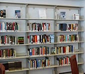 Extensive library shelves filled with books in a well-lit academic setting for higher education and college success.