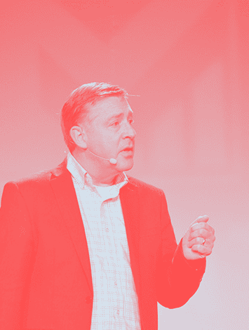 Elevated speaker delivering a presentation on college completion strategies at Complete College America event.