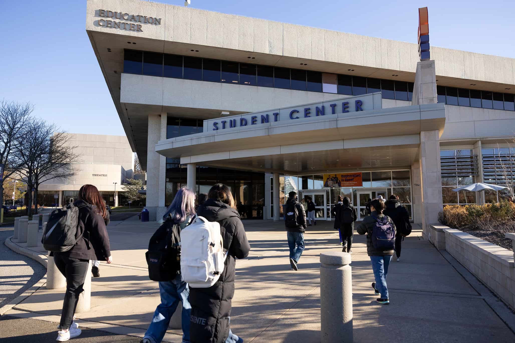 Students entering a college student center at a community college campus.