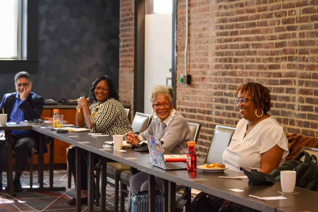 Complete college America conference with diverse professionals discussing higher education strategies.