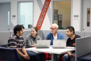 Discovery and discussion among diverse students at Complete College America initiative, promoting college success, retention, and educational equity, modern learning environment, collaborative student support.