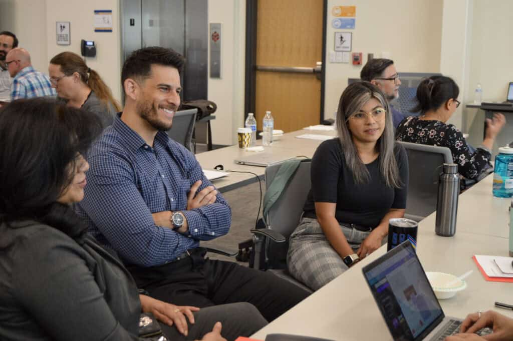 Engaged diverse professionals participating in a workshop at a conference or seminar, emphasizing higher education collaboration, professional development, and community engagement in college settings.
