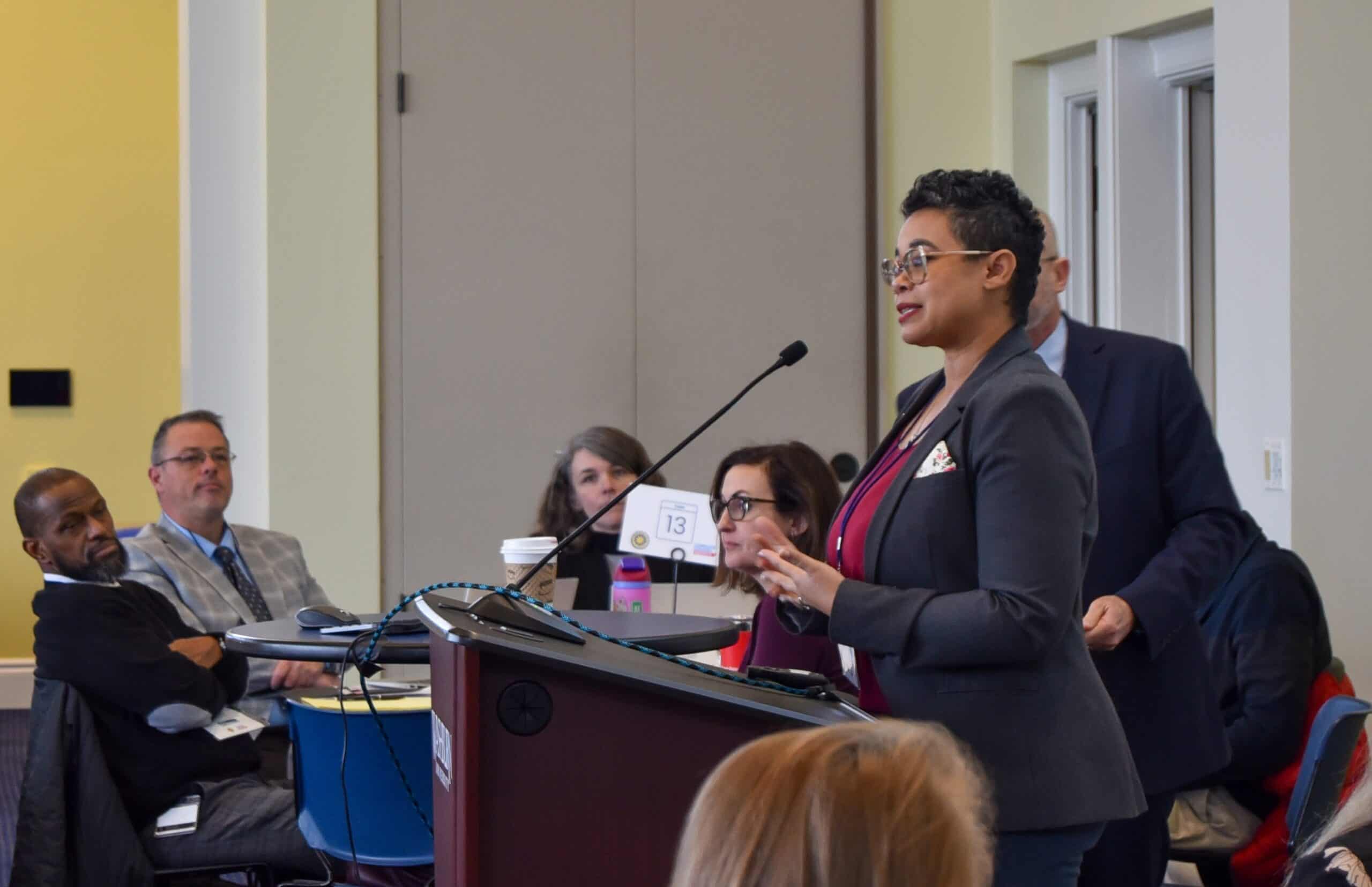 Diversity in education with a woman speaker presenting at a conference focused on Complete College America initiatives.
